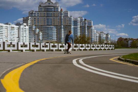 Young man rides a skateboard in the city.