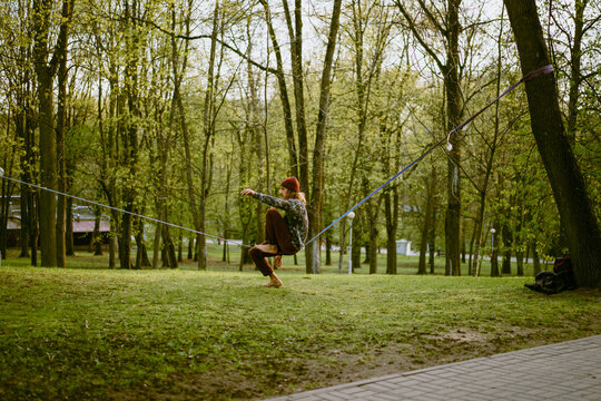 Young man balancing on slackline.