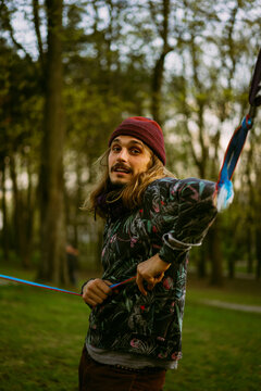 Man sets a slackline in the city park.