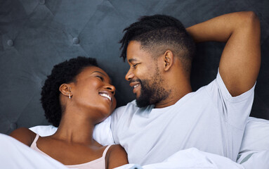 Black couple and eye contact in bed with romance for love with tender, embrace and care in morning...