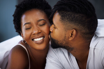 Black couple and kiss on cheek with closeup in bedroom with smile for love, embrace and care in...