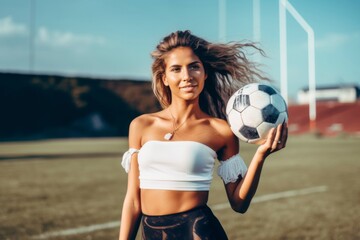 woman with soccer ball in sports field