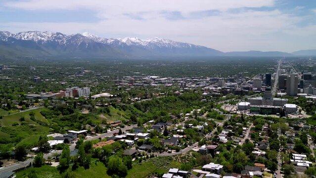 Aerial view of Salt Lake cityscape, with snow-covered mountains in the background in Utah, USA
