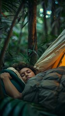 Obraz premium A woman is sleeping in a hammock in a jungle