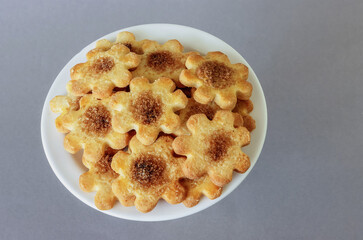 on a plate a bunch of cookies with cinnamon and sugar, view and top
