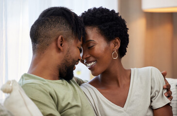 African couple, love and smile in home for commitment, marriage and together on sofa for relax....