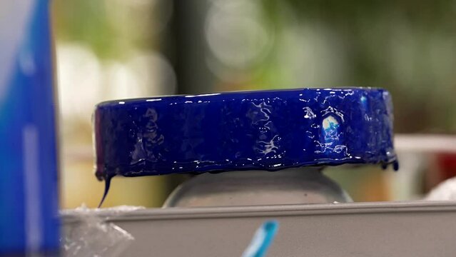 the pastry chef completes the cake with a delicious and spectacular blue icing decoration
