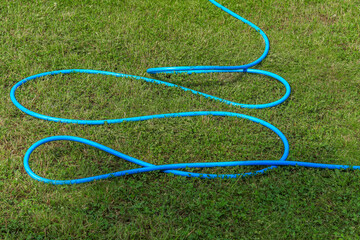 Blue garden hose for watering the lawn