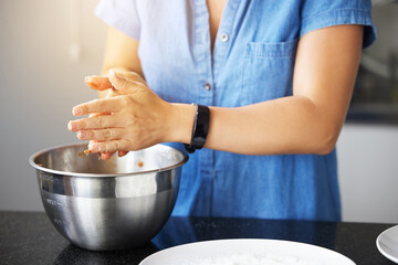 Person, hands and baking bowl in kitchen or mixing ingredients as pastry chef, recipe or breakfast....