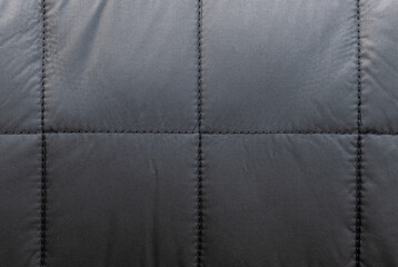 Texture black leather sofa has square seams.