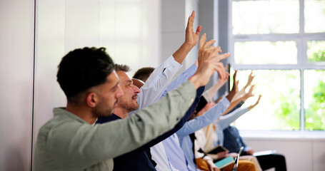 Business People Vote And Raise Questions At Team Event