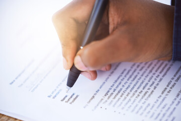 Contract, hand and pen with employee for application, agreement and signing paperwork. Document, person and writing form for recruitment or hiring, signature approval or office and paper on table