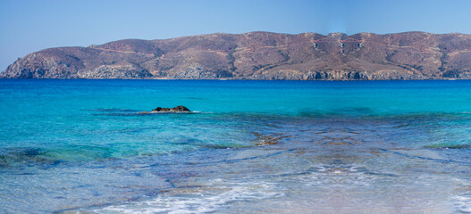 a splendid crystal clear sea in front of a splendid desert island