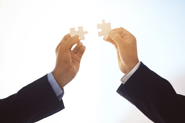 Hands, puzzle piece and businesspeople in sky for connection, teamwork and support in partnership....