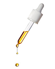 Yellow essential serum oil dripping from gold dropper isolated on white background. Clipping path.