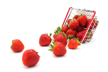 Overturned shopping supermarket basket with fresh organic ripe scattered strawberries isolated on a white background. Purchase of products. Agricultural products and harvesting.