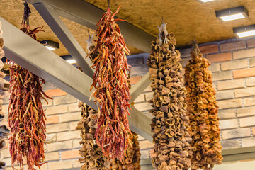 Dried aubergines and peppers hanging in spice shop at turkish bazaar market