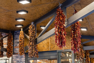 Dried aubergines and peppers hanging in spice shop at turkish bazaar market