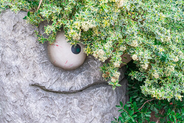 a comic fairy-tale sculpture made of stone in the park