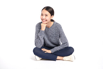 Beautiful young asian woman smiling happy and sitting on the floor on white background, Young...
