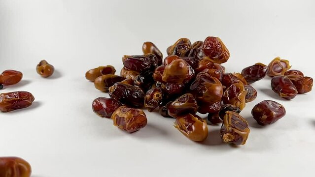 slow motion shot of falling dates, closeup of fard dates, fresh dates 