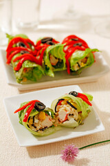 Lettuce rolls with rice, seaweed and surimi.