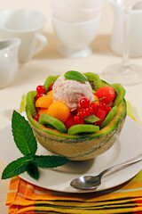Stuffed melon with fruits and ice cream.