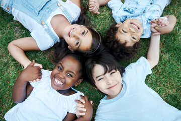 Portrait, top view and kids on grass, holding hands and happiness with weekend break, outdoor and...