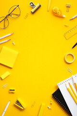 Flat lay vertical composition with office supplies on yellow background. Perfect for themes related...