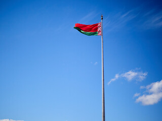 National flag of the Republic of Belarus against the blue sky