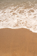 Sea wave and sand on the beach with copy space for text. 