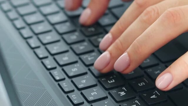 Slow motion footage of the woman working on the laptop. Technology