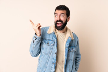 Caucasian man with beard over isolated background intending to realizes the solution while lifting a finger up