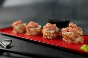 Japanese food: sushi, Shiitaki roll with tuna, avocado, Philadelphia, kimchi, tuna flakes Black background