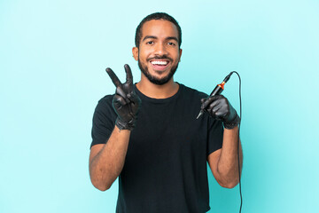 Tattoo artist Ecuadorian man isolated on blue background smiling and showing victory sign