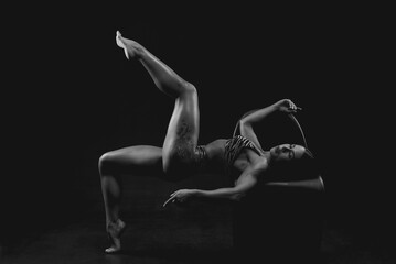 Black and white image of a sports woman in the studio. Beautiful body.