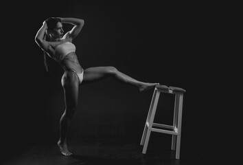 Black and white image of a sports woman in the studio. Beautiful body.