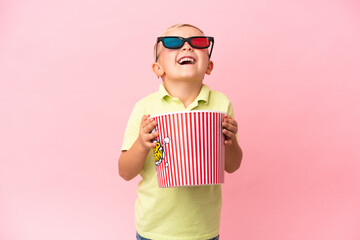Little Russian boy eating popcorns in a big bowl over isolated background