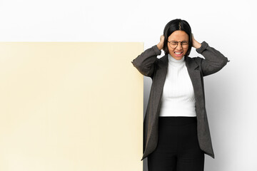Young business mixed race woman with with a big banner over isolated background frustrated and covering ears