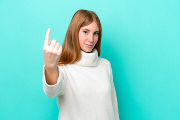 Young redhead woman isolated on blue background doing coming gesture