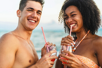 Multiethnic Couple Enjoying Refreshing Drinks on the Beach - Summer Fun