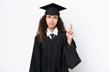 Young university graduate Arab woman isolated on white background with fingers crossing and wishing...