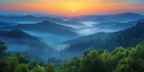 Obraz premium Majestic sunrise over misty mountains, mysterious woodland, and scenic valley under autumn sky.