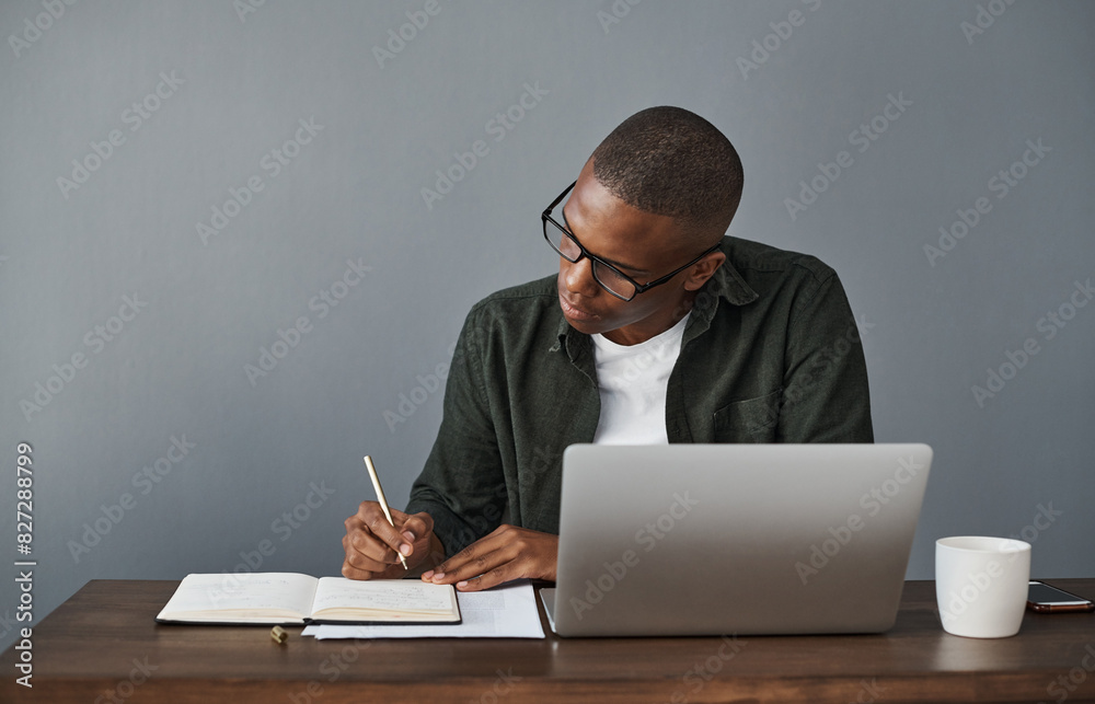 Poster office, laptop and black man writing notes for research, schedule and online information in creative