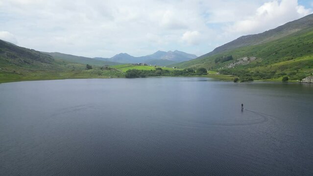 Ascending drone shot of Llynnau Mymbyr lakes in Dyffryn Mymbyr valley near Capel Curig, Wales, UK