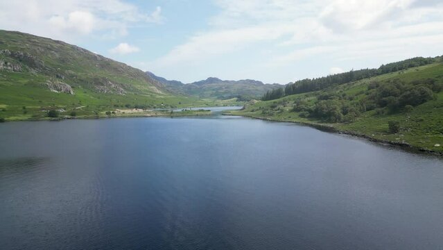 Ascending drone shot of the scenic Llynnau Mymbyr lakes near Capel Curig village, north Wales, UK