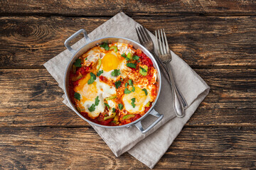 Homemade shakshuka,fried eggs, onion, bell pepper, tomatoes and cilantro
