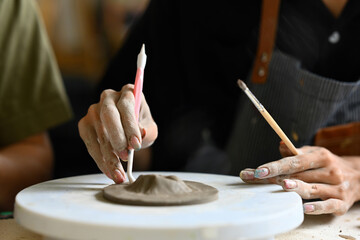 Closeup Image of a Young man's hands working with clay, making ceramic, Ceramic Young Artist taking...