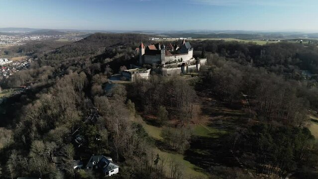 Aerial view of Veste Coburg fortress with trees around it, on a hill above Coburg in Germany