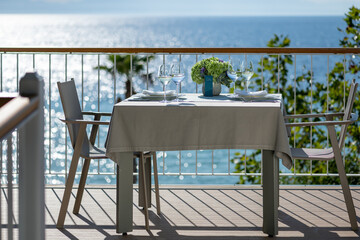 Summer terrace with stylish trendy outdoor furniture at a luxurious travel destination.